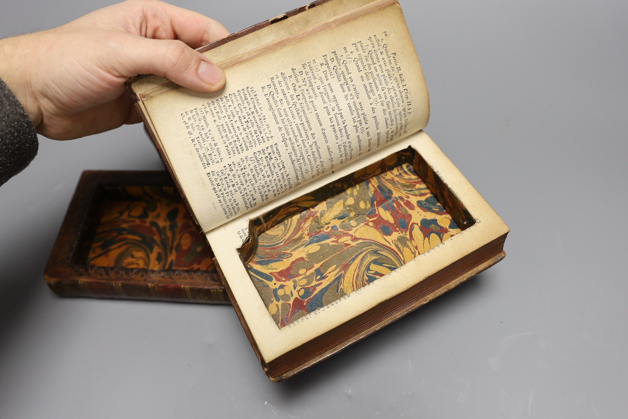 An 18th century leather bound book safe, formed of three leather bound volumes, 9 cms high x 17 wide